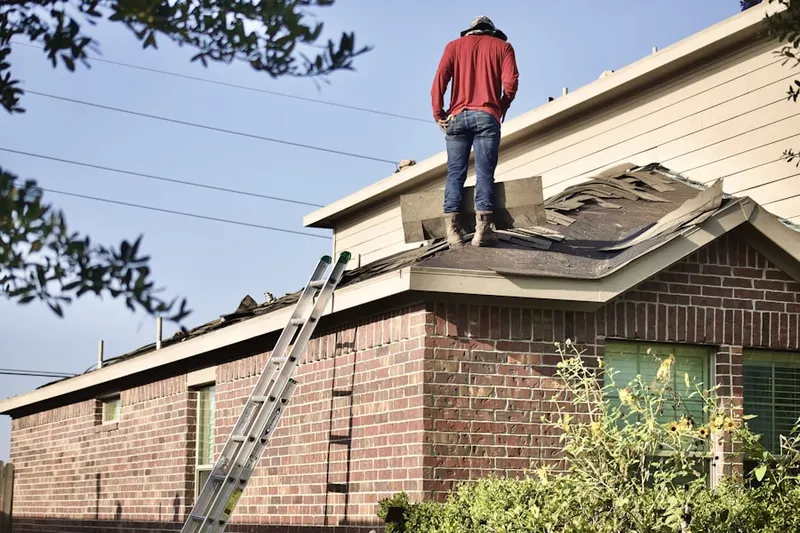 Professional roofer working on a residential roof in Palatine